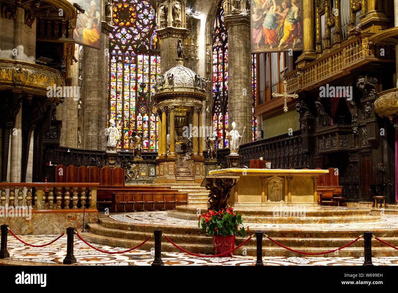 The altar with stained glass windows in the background. Duomo di Milano (Milan Cathedral). Stock Photo