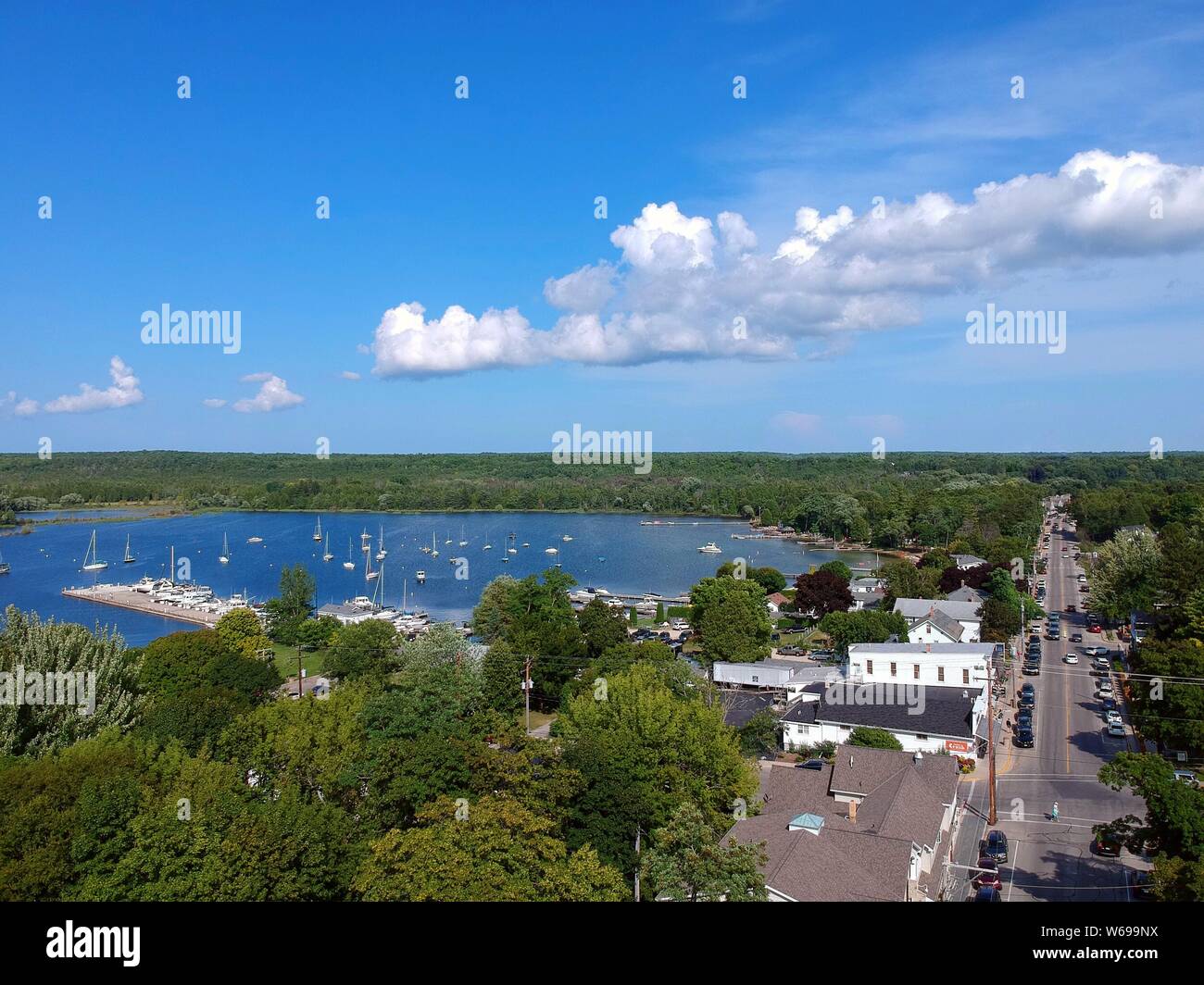 Drone shot of Dane County Wisconsin looking down onto road and lake with boats Stock Photo