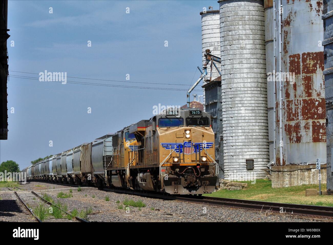 Union Pacific Train with grain Elevators in Wilson Kansas USA with blue