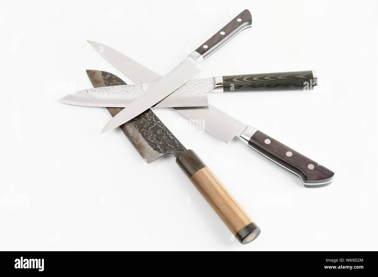 Four different knives on light gray surface Stock Photo