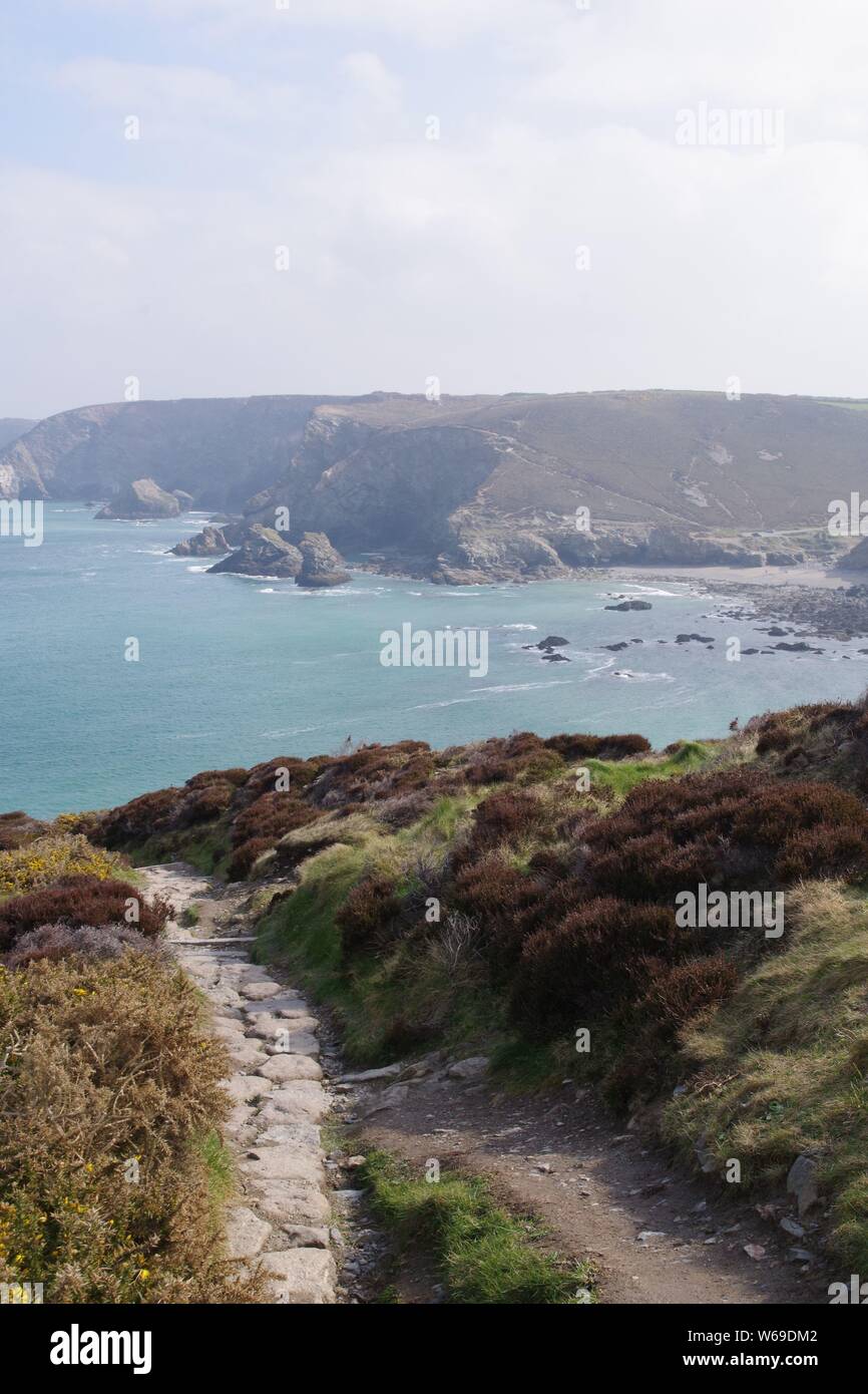 South West Coastal Path around St Agnes Head on a Hazy Spring Day, looking towards Trevaunance Cove. North Cornwall, UK. Stock Photo