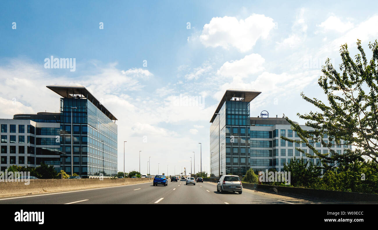 Paris, France - Jul 15, 2019: Office buildings headquarters with Dell Computers logotype on the top of the building on Avenue du Stade de France - view from the car driving on Avenue Peripheriques Stock Photo