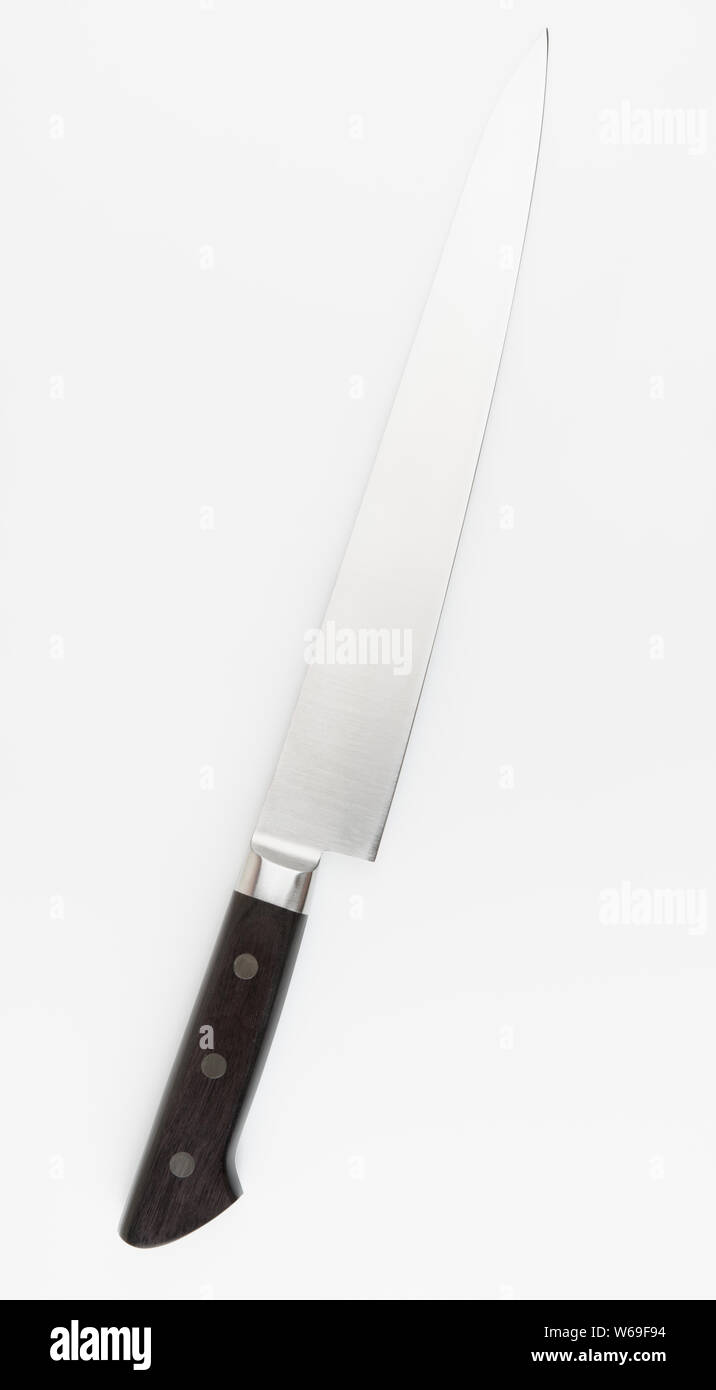 Long chef kitchen knife shot on light grey background Stock Photo - Alamy