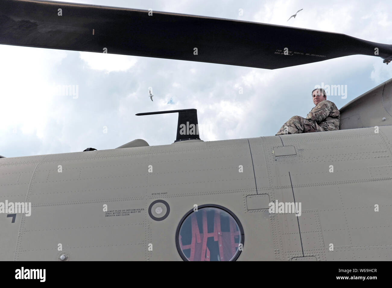 US Army female sits atop a United States Army aircraft at the Cleveland National Air Show in Cleveland, Ohio, USA. Stock Photo