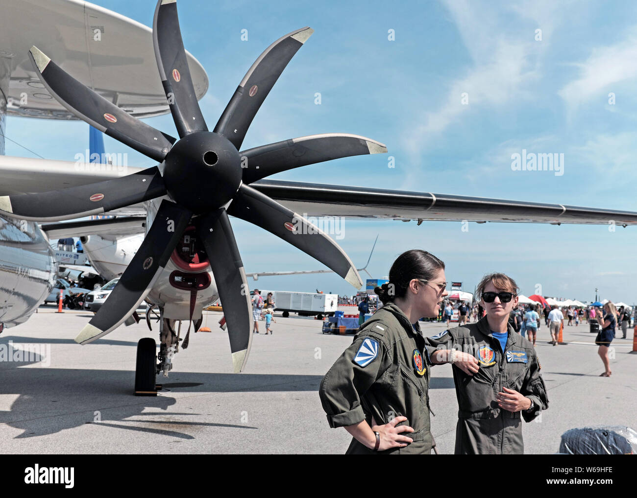 Two female Navy pilots stand alongside a Hawkeye aircraft on display at the Burke Lakefront Airport Labor Day National Air Show in Cleveland, Ohio. Stock Photo