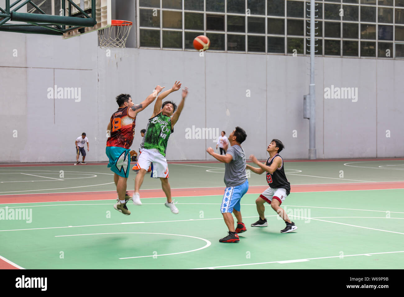 Male Hongkongers playing basketball on Southorn Playground in Wan Chai