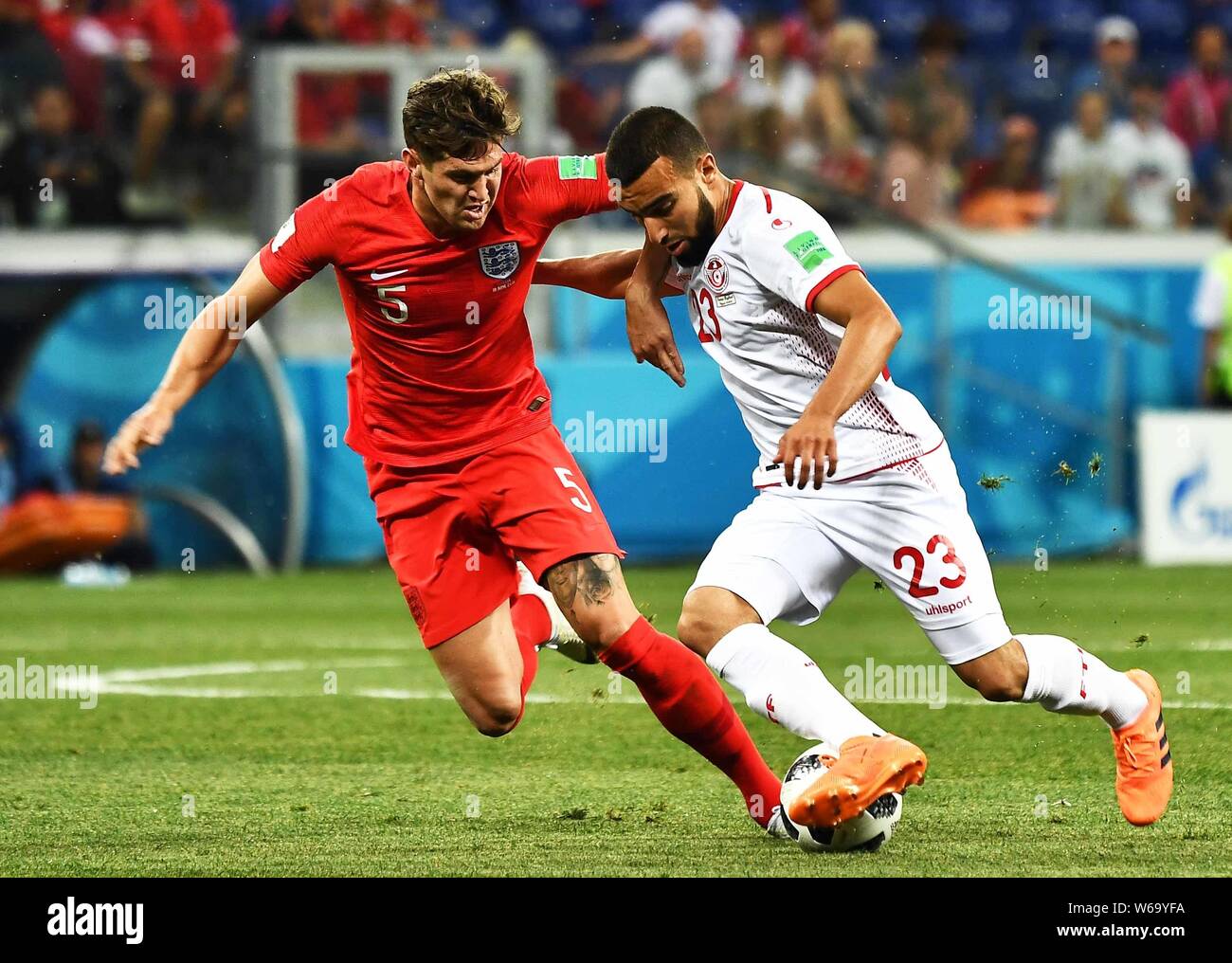 John Stones of England, left, challenges Naim Sliti of Tunisia in their Group G match during the 2018 FIFA World Cup in Volgograd, Russia, 18 June 201 Stock Photo