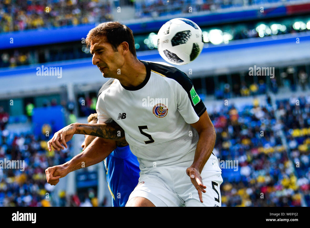 Celso Borges, top, of Costa Rica heads the ball to make a pass against Neymar of Brazil in their Group E match during the FIFA World Cup 2018 in Saint Stock Photo