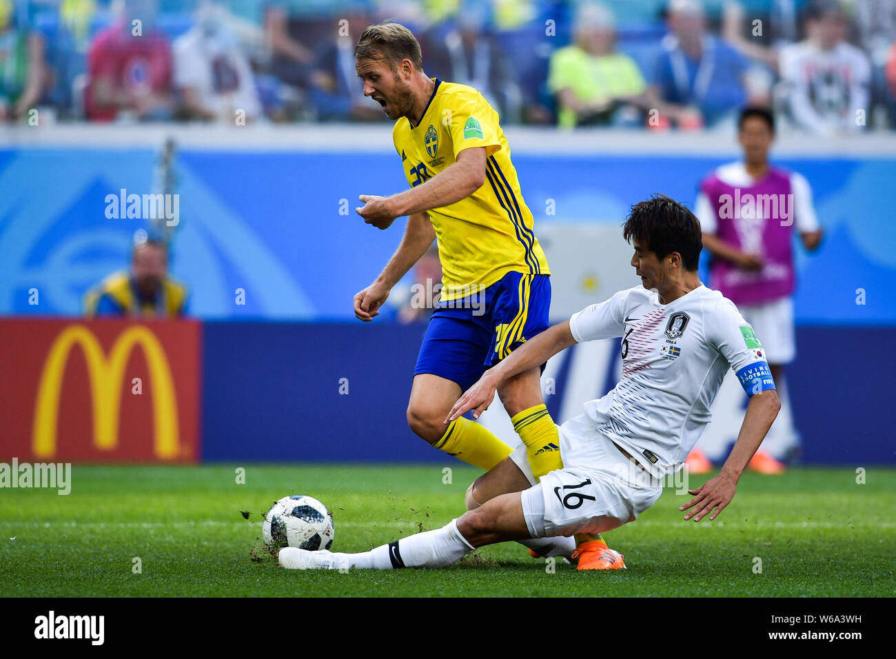 Ki Sung-yueng of South Korea, right, slide-tackles Ola Toivonen of Sweden in their Group F match during the FIFA World Cup 2018 in Nizhny Novgorod, Ru Stock Photo
