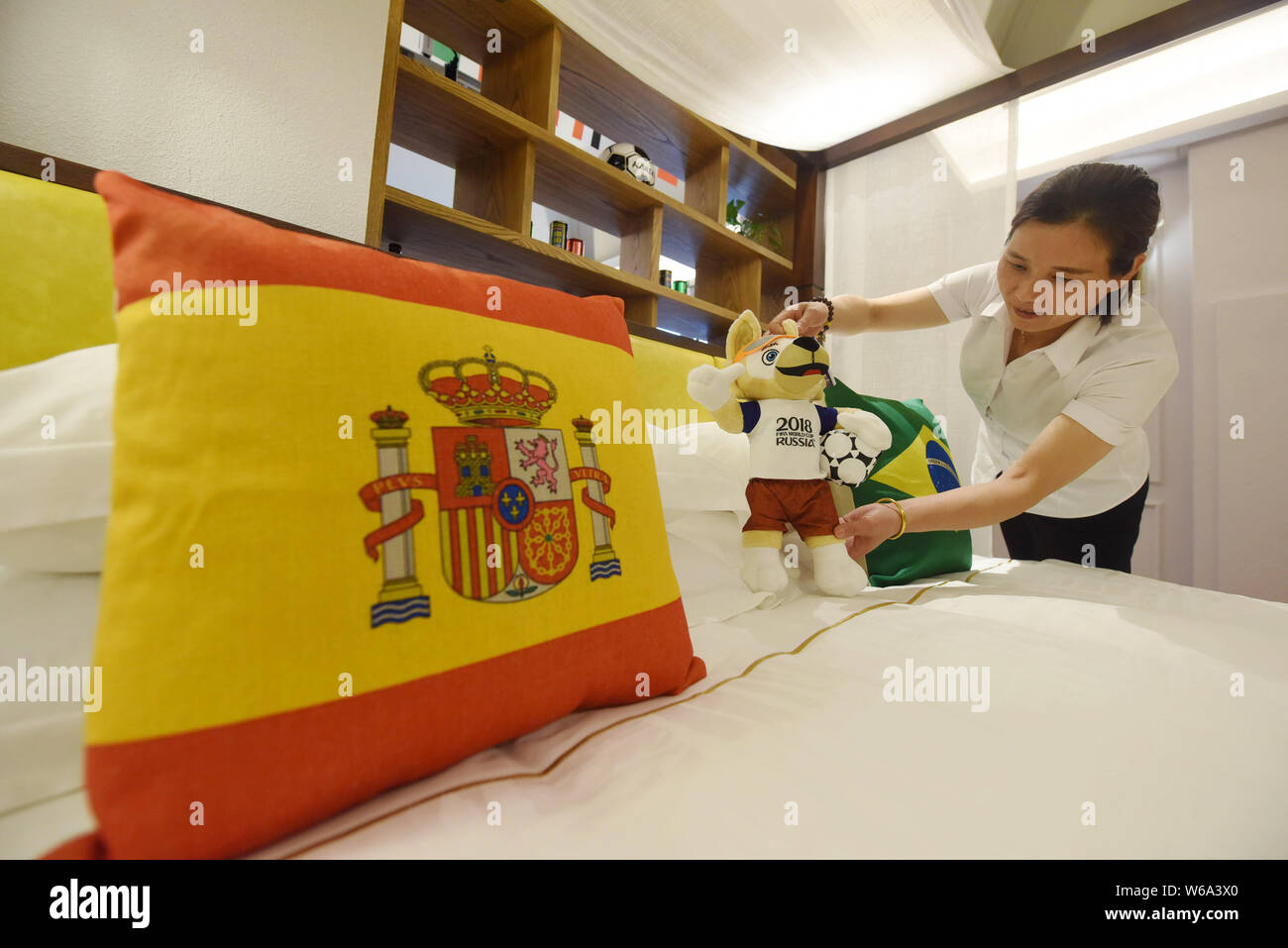 A Chinese room attendant works at a World Cup-themed room launched by a hotel to preheat the upcoming 2018 FIFA World Cup in Thousand Island Lake area Stock Photo