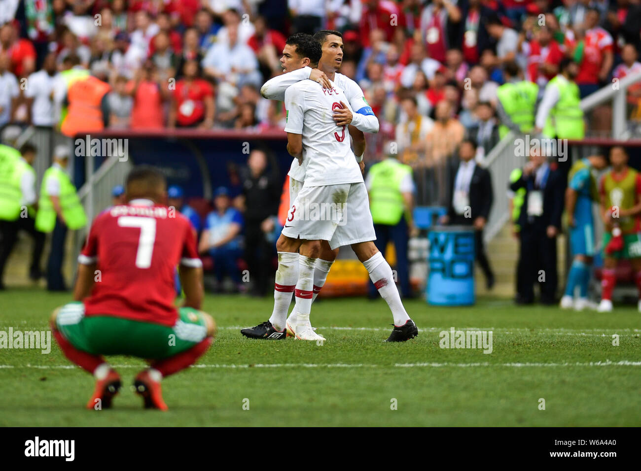Cristiano Ronaldo of Portugal, back, celebrates with Pepe after defeating Morocco in their Group B match during the 2018 FIFA World Cup in Moscow, Rus Stock Photo