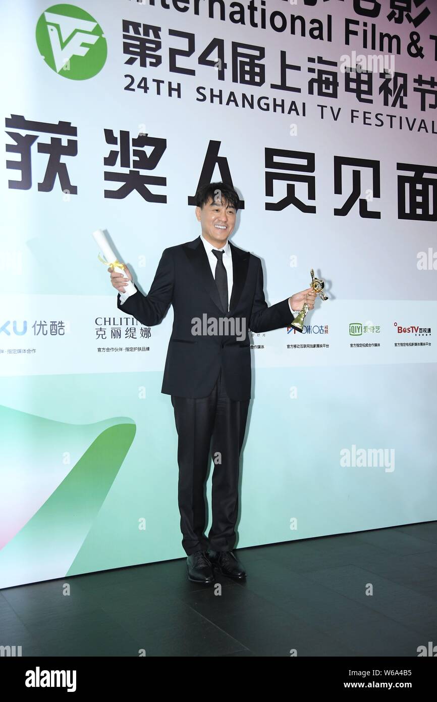 Chinese actor He Bing poses with his trophy for the Best Actor award for his role in the TV drama 'Romantic Full House' during the closing ceremony of Stock Photo