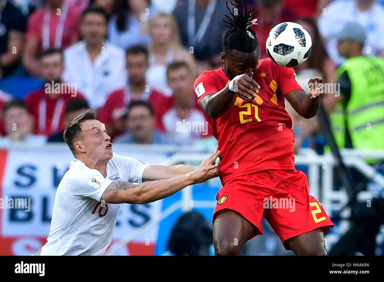 Michy Batshuayi of Belgium, right, heads the ball against Phil Jones of England in their Group G match during the 2018 FIFA World Cup in Kaliningrad, Stock Photo
