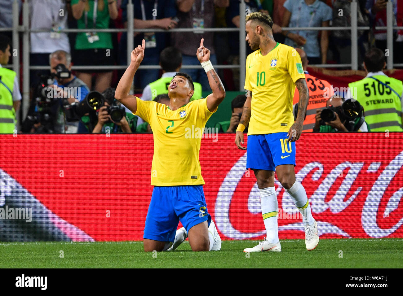 Thiago Silva, left, of Brazil kneels down to pray as he celebrates next to Neymar after scoring a goal against Serbia in their Group E match during th Stock Photo