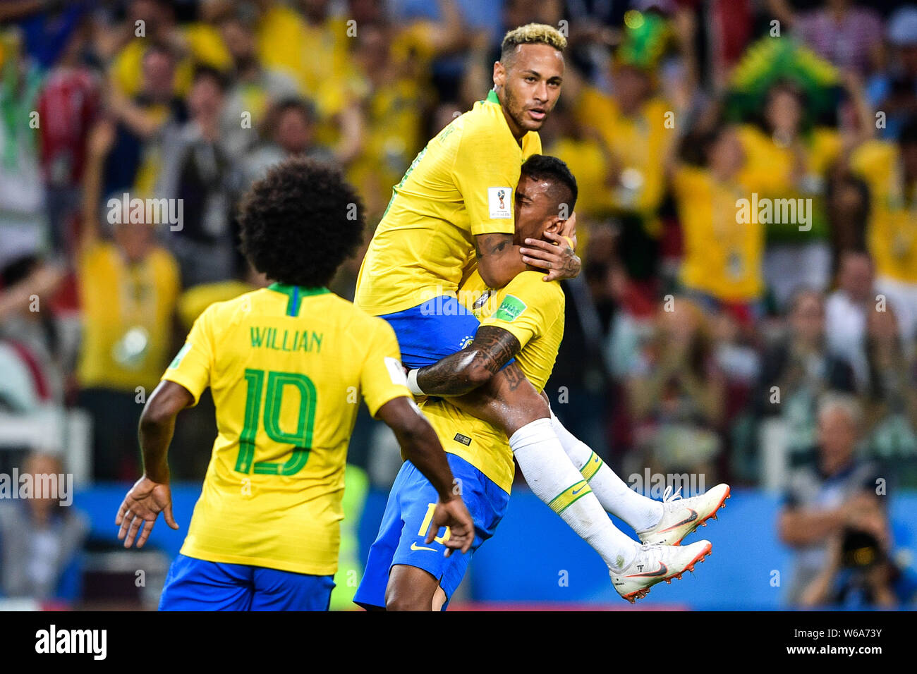 Paulinho, right, of Brazil celebrates with Neymar and Willian after scoring a goal against Serbia in their Group E match during the FIFA World Cup 201 Stock Photo