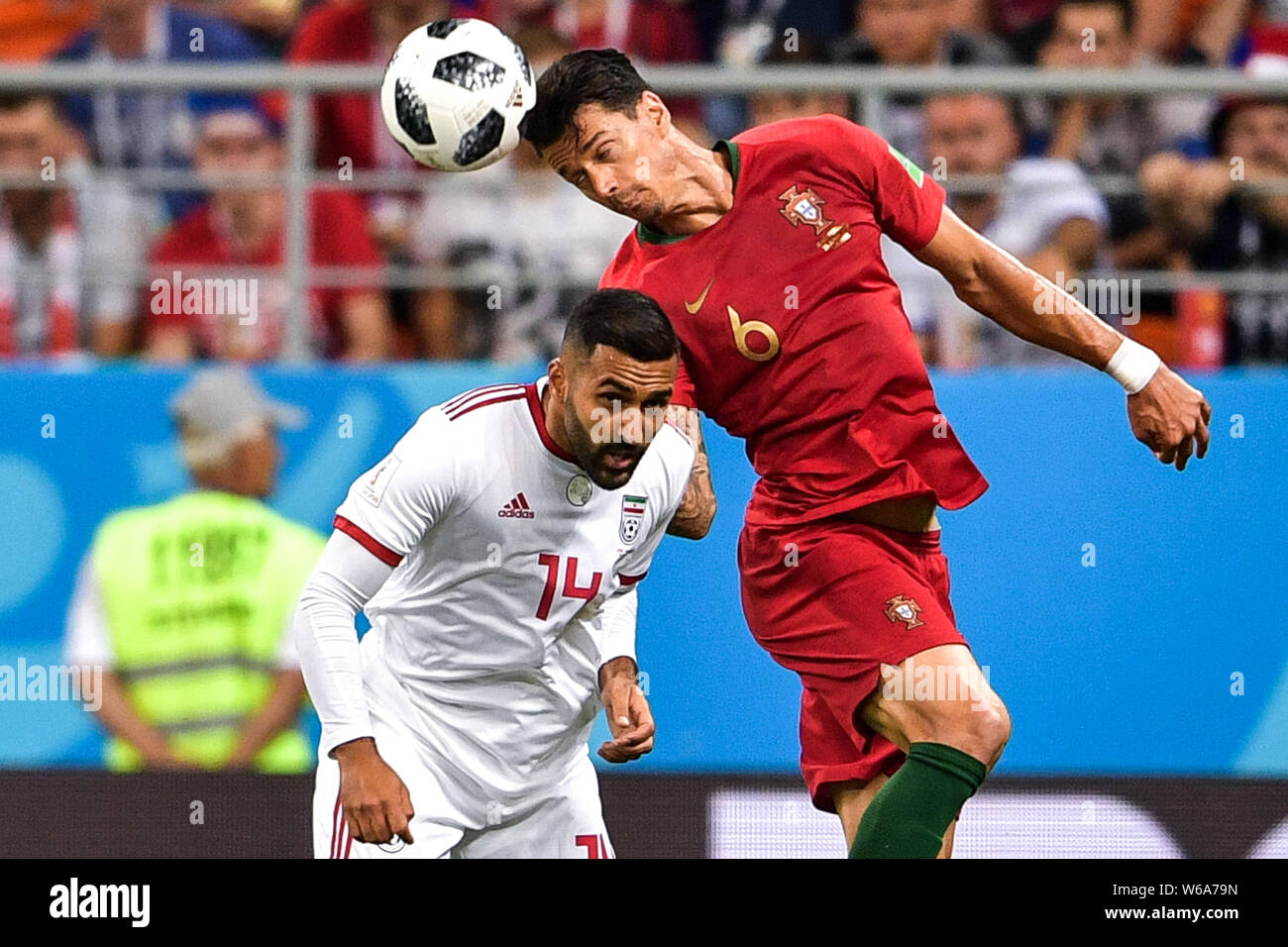 Jose Fonte of Portugal, right, heads the ball against Saman Ghoddos of Iran in their Group B match during the 2018 FIFA World Cup in Saransk, Russia, Stock Photo