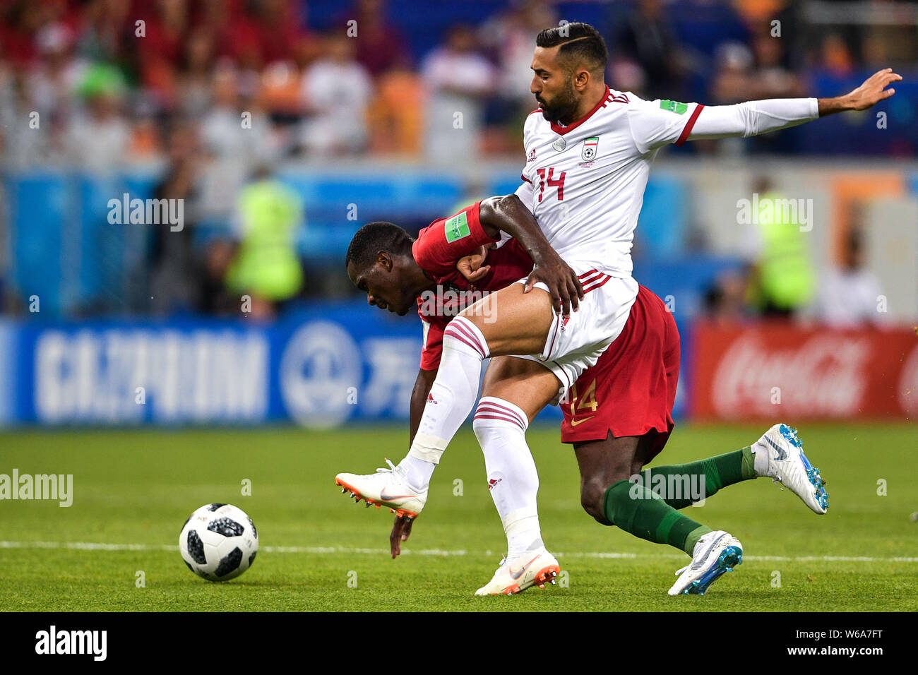 William Carvalho of Portugal, back, challenges Saman Ghoddos of Iran in their Group B match during the 2018 FIFA World Cup in Saransk, Russia, 25 June Stock Photo