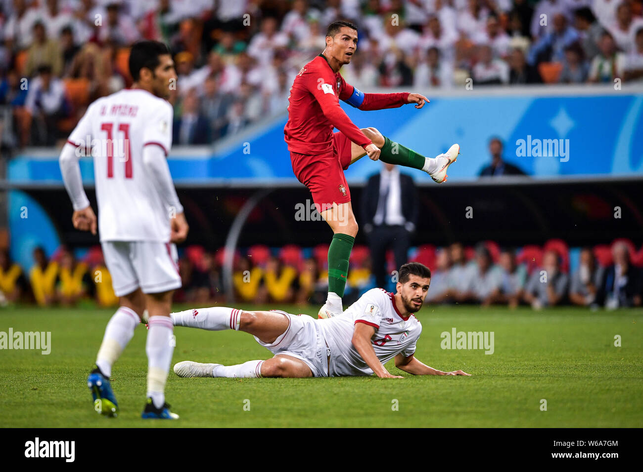 Cristiano Ronaldo of Portugal, top, challenges Morteza Pouraliganji of Iran in their Group B match during the 2018 FIFA World Cup in Saransk, Russia, Stock Photo