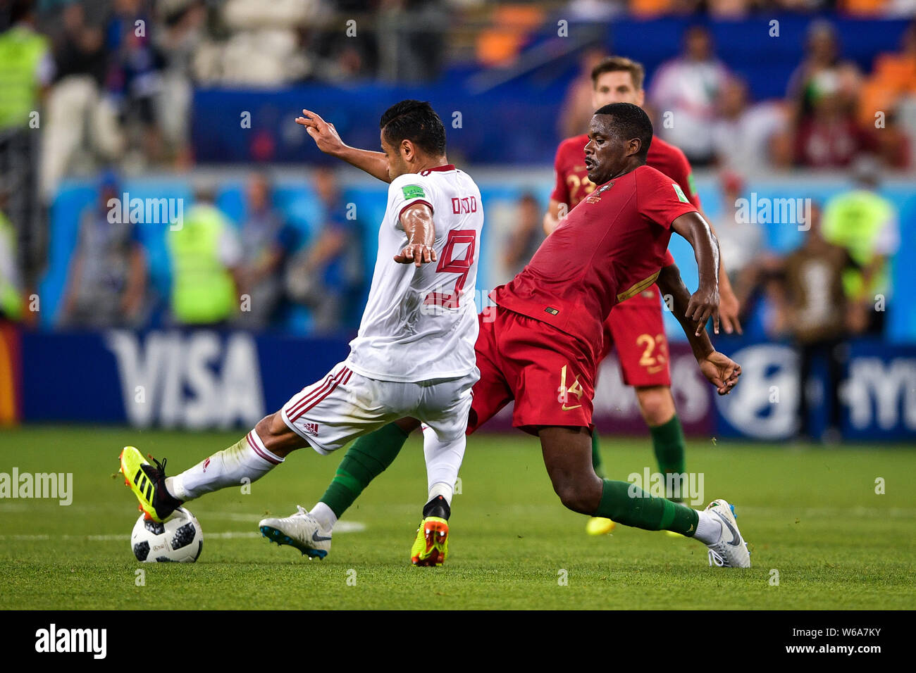 William Carvalho of Portugal, right, challenges Omid Ebrahimi of Iran in their Group B match during the 2018 FIFA World Cup in Saransk, Russia, 25 Jun Stock Photo