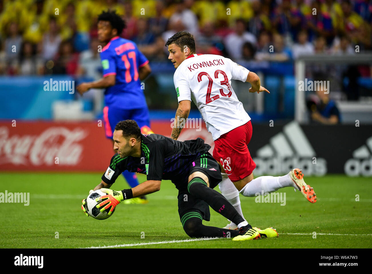 Goalkeeper David Ospina of Colombia, bottom, saves the ball from Dawid Kownacki of Poland in their Group H match during the FIFA World Cup 2018 in Kaz Stock Photo