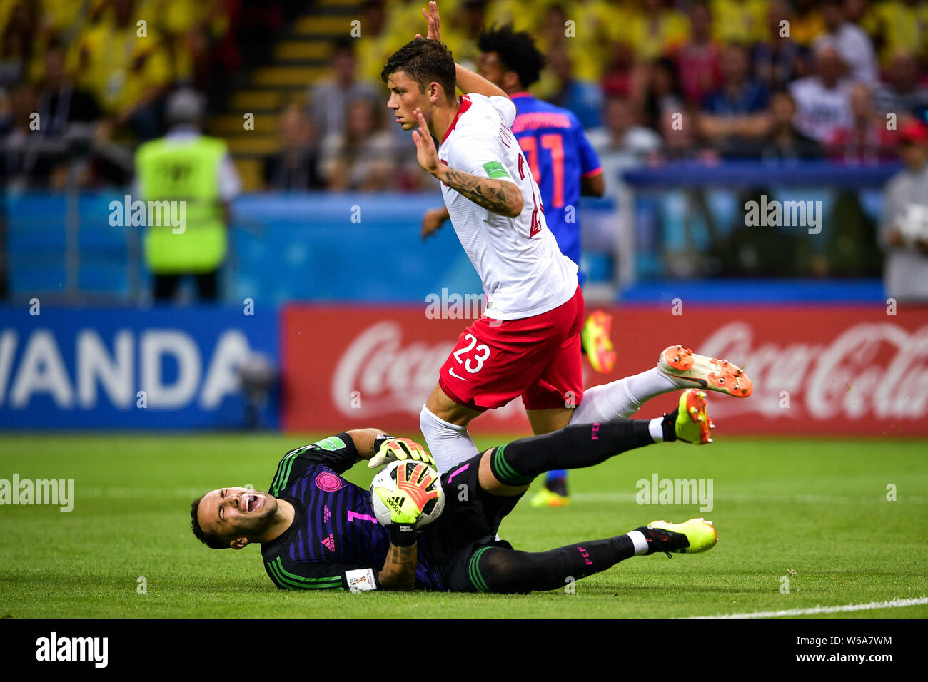 Goalkeeper David Ospina of Colombia, bottom, reacts after fouled by Dawid Kownacki of Poland in their Group H match during the FIFA World Cup 2018 in Stock Photo