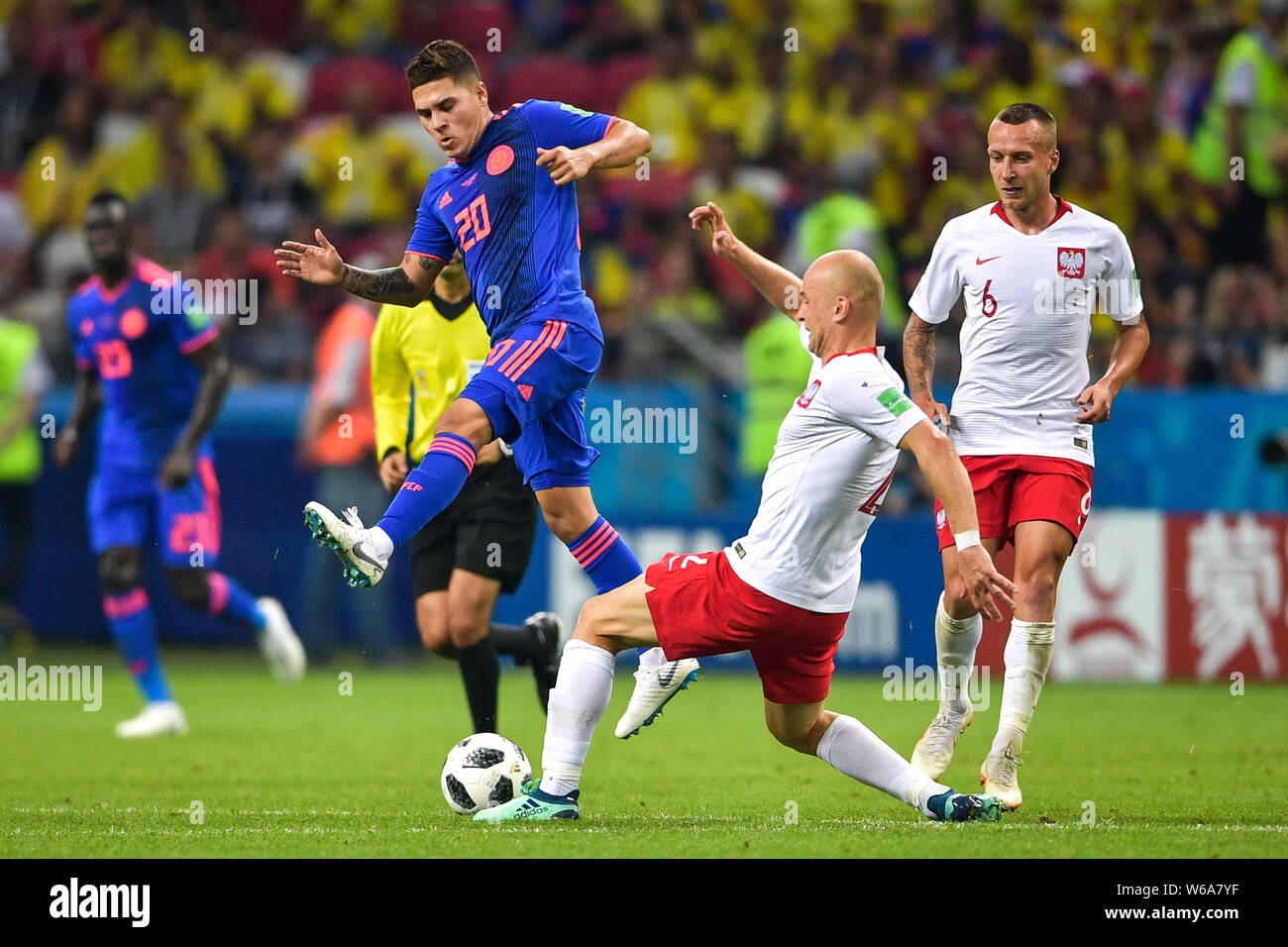 Juan Fernando Quintero of Colombia, left, challenges Michal Pazdan of Poland in their Group H match during the FIFA World Cup 2018 in Kazan, Russia, 2 Stock Photo