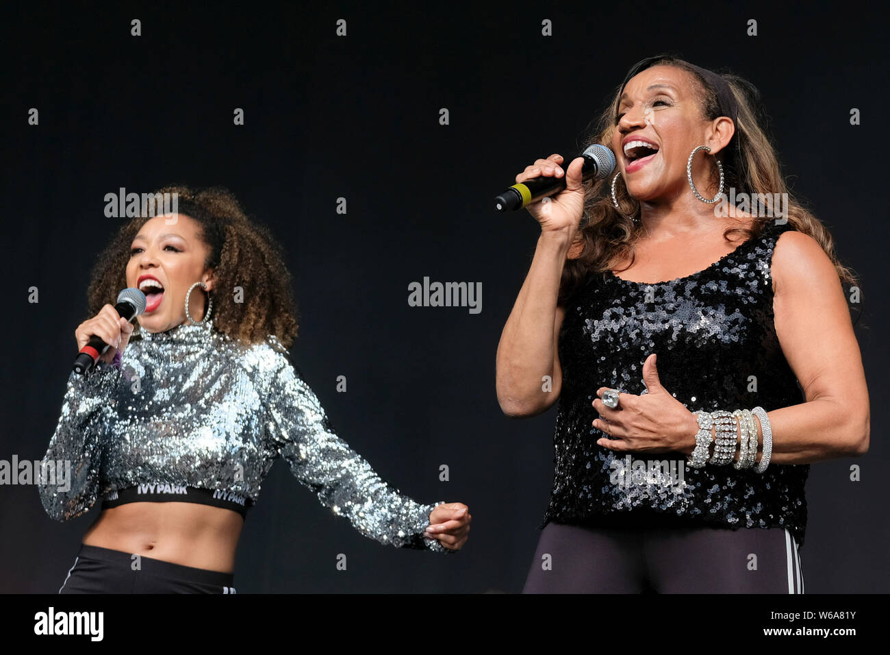 Lulworth, UK. 28th July, 2019. Kathy Sledge, one of the original female vocalists with Grammy Award winning American musical vocal group Sister Sledge, performing live on stage with a backing vocalist at Camp Bestival family music festival in Lulworth, Dorset, UK Credit: SOPA Images Limited/Alamy Live News Stock Photo
