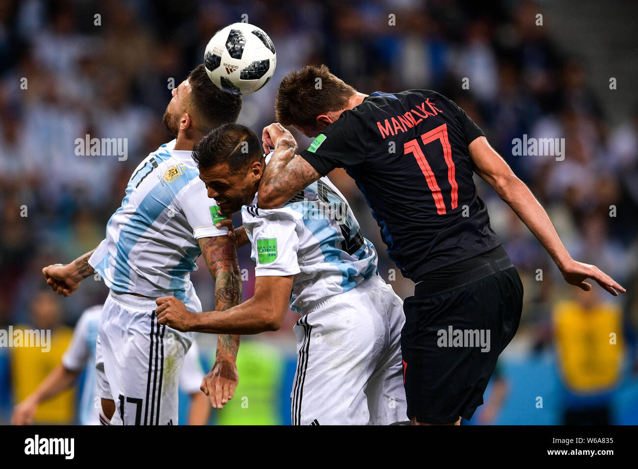 Nicolas Otamendi and Gabriel Mercado of Argentina head the ball against Mario Mandzukic of Croatia in their Group D match during the 2018 FIFA World C Stock Photo