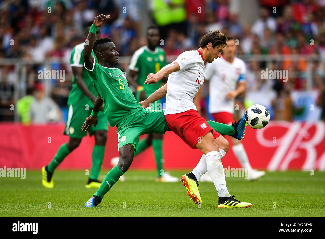 Grzegorz Krychowiak of Poland, right, challenges Idrissa Gueye of Senegal in their Group H match during the FIFA World Cup 2018 in Moscow, Russia, 19 Stock Photo