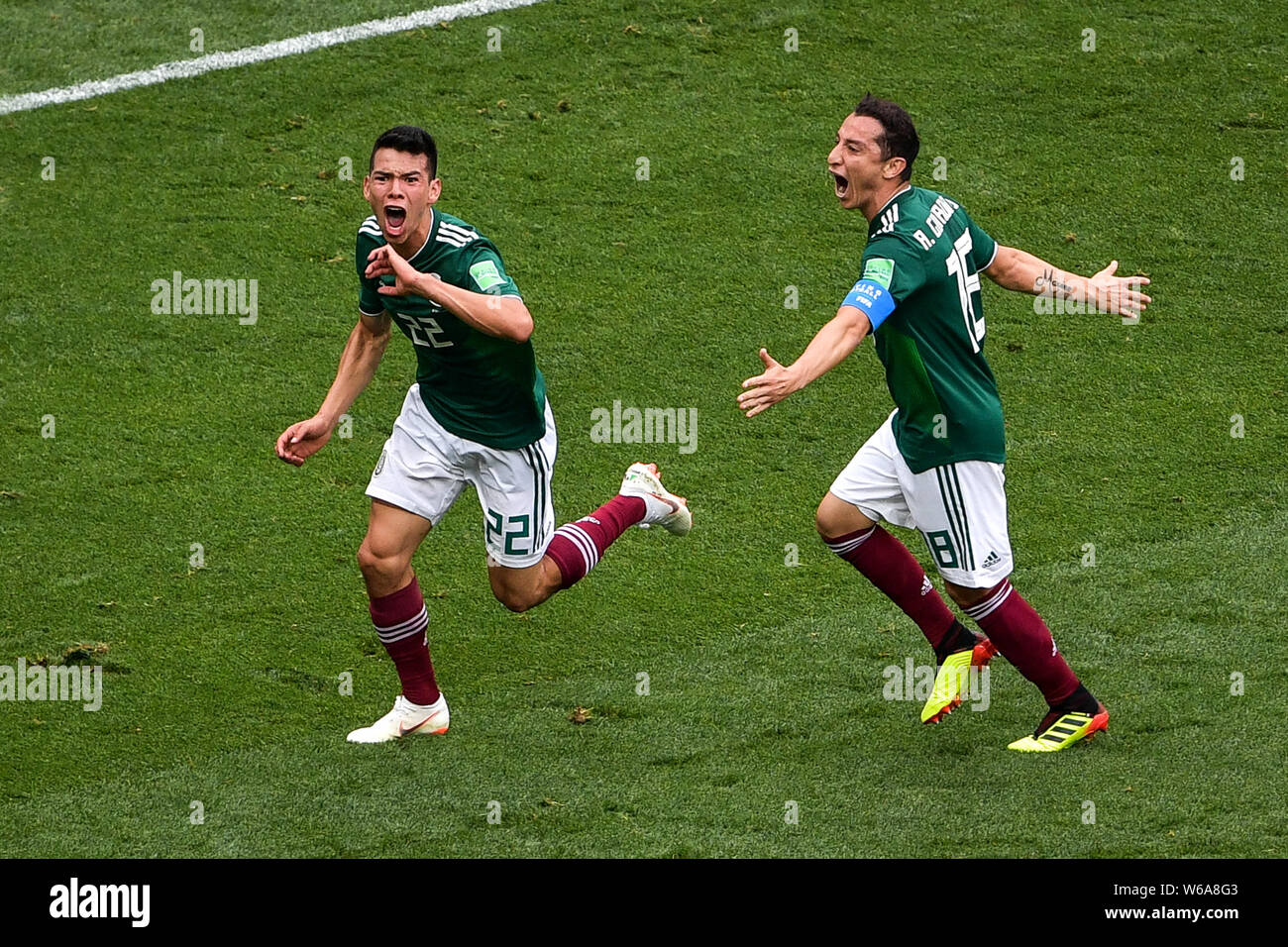 Hirving Lozano, left, of Mexico celebrates with Andres Guardado after scoring a goal against Germany in their Group F match during the FIFA World Cup Stock Photo