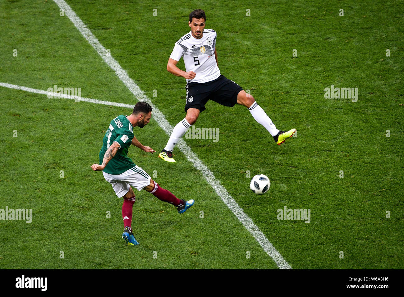 Miguel Layun of Mexico, left, shoots against Mats Hummels of Germany in their Group F match during the 2018 FIFA World Cup in Moscow, Russia, 17 June Stock Photo