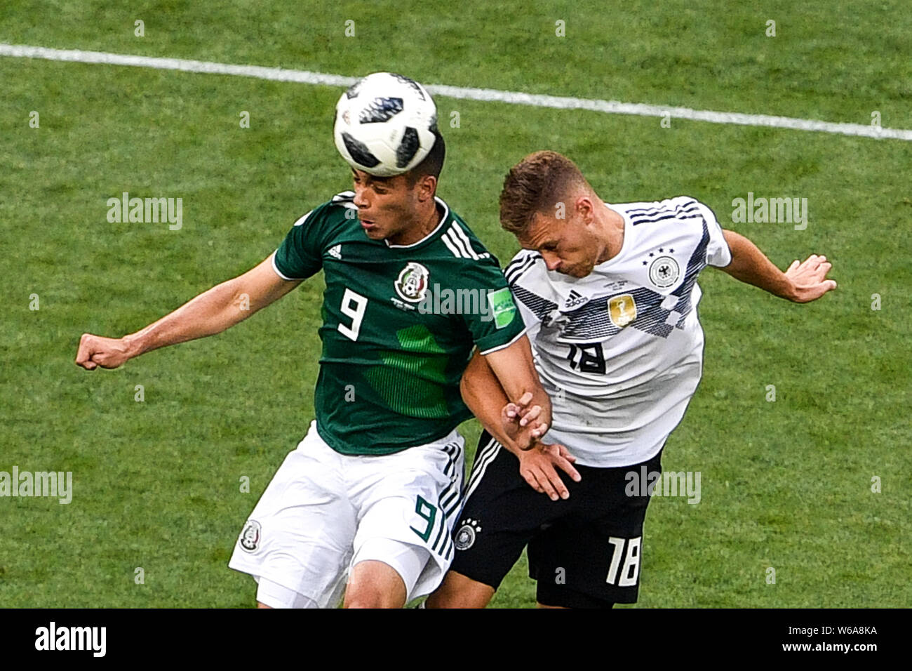 Raul Jimenez of Mexico, left, heads the ball against Joshua Kimmich of Germany in their Group F match during the 2018 FIFA World Cup in Moscow, Russia Stock Photo