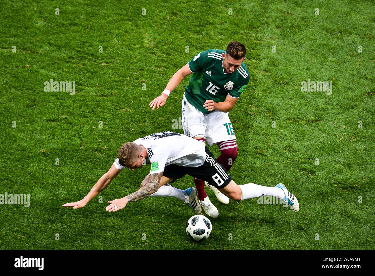 Hector Herrera of Mexico, back, challenges Toni Kroos of Germany in their Group F match during the 2018 FIFA World Cup in Moscow, Russia, 17 June 2018 Stock Photo