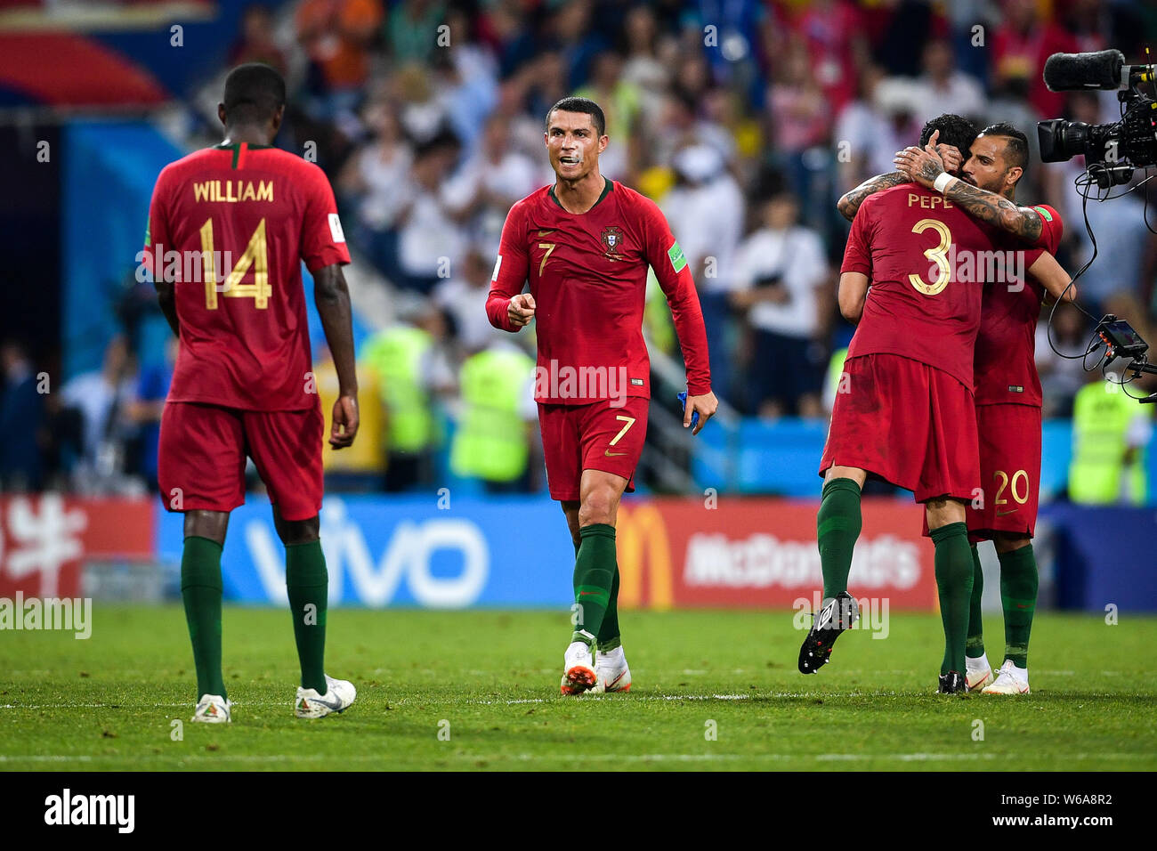Cristiano Ronaldo, center, of Portugal interacts with his teammate William Carvalho after playing a draw against Spain in their Group B match during t Stock Photo