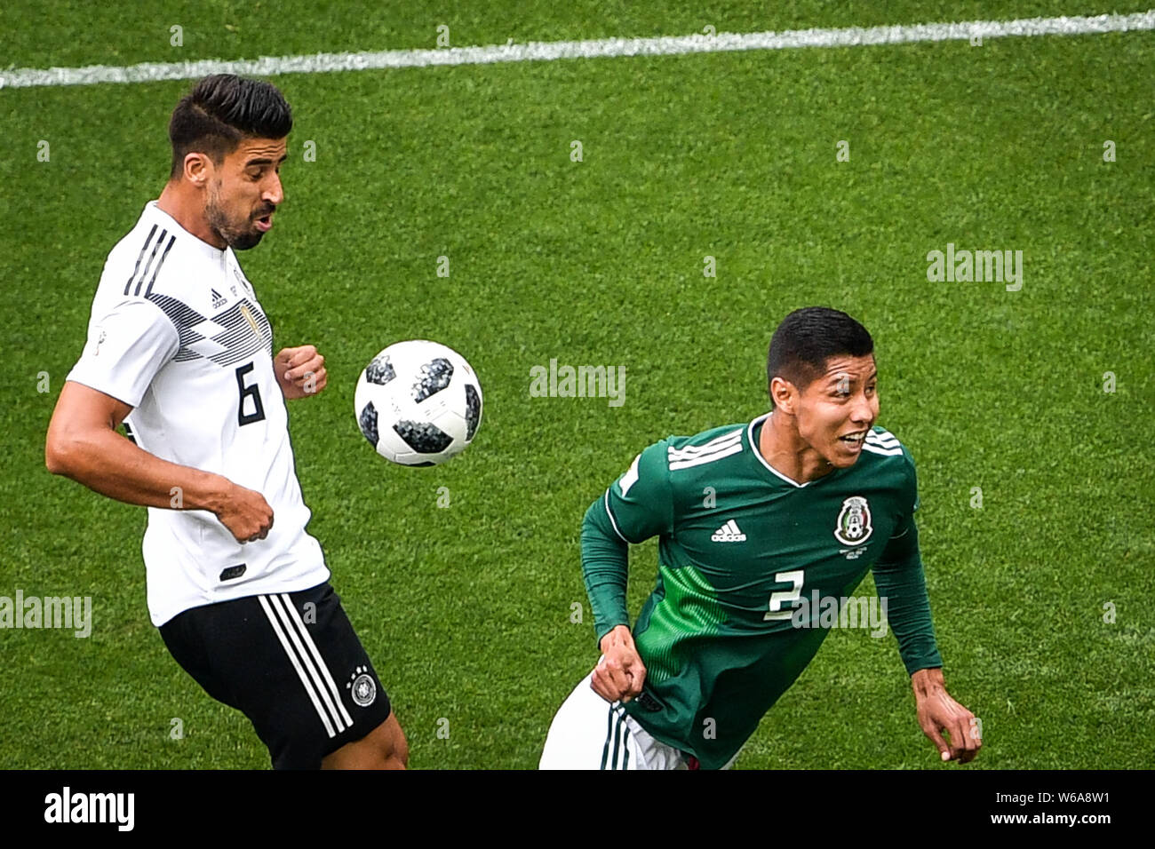 Hugo Ayala of Mexico, right, challenges Sami Khedira of Germany in their Group F match during the 2018 FIFA World Cup in Moscow, Russia, 17 June 2018. Stock Photo