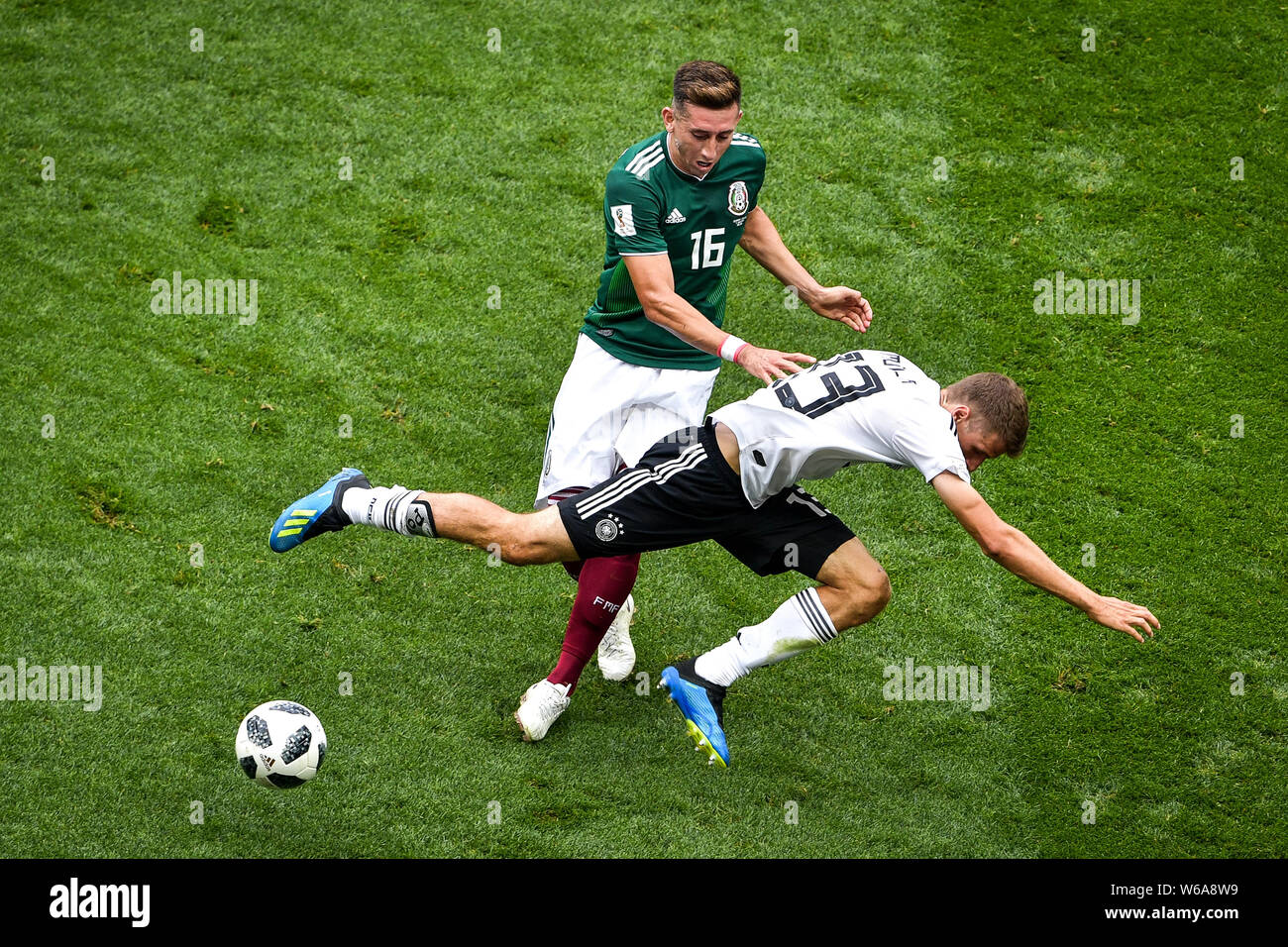 Thomas Mueller (Muller) of Germany, front, challenges Hector Herrera of Mexico in their Group F match during the FIFA World Cup 2018 in Moscow, Russia Stock Photo