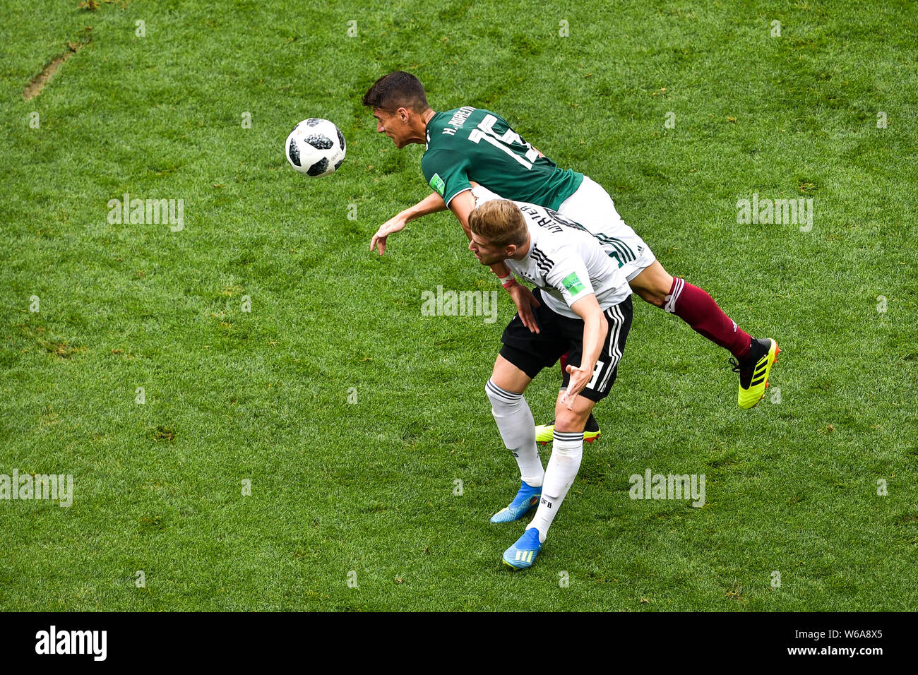 Hector Moreno of Mexico, upper, heads the ball against Germany in their Group F match during the 2018 FIFA World Cup in Moscow, Russia, 17 June 2018. Stock Photo
