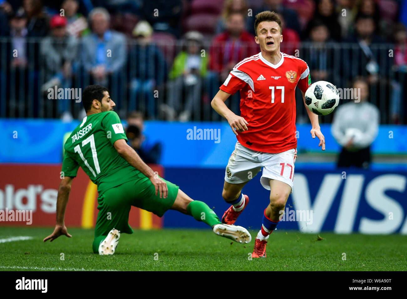 Aleksandr Golovin of Russia, right, challenges Taisir Al-Jassim of Saudi Arabia in their Group A match during the 2018 FIFA World Cup in Moscow, Russi Stock Photo
