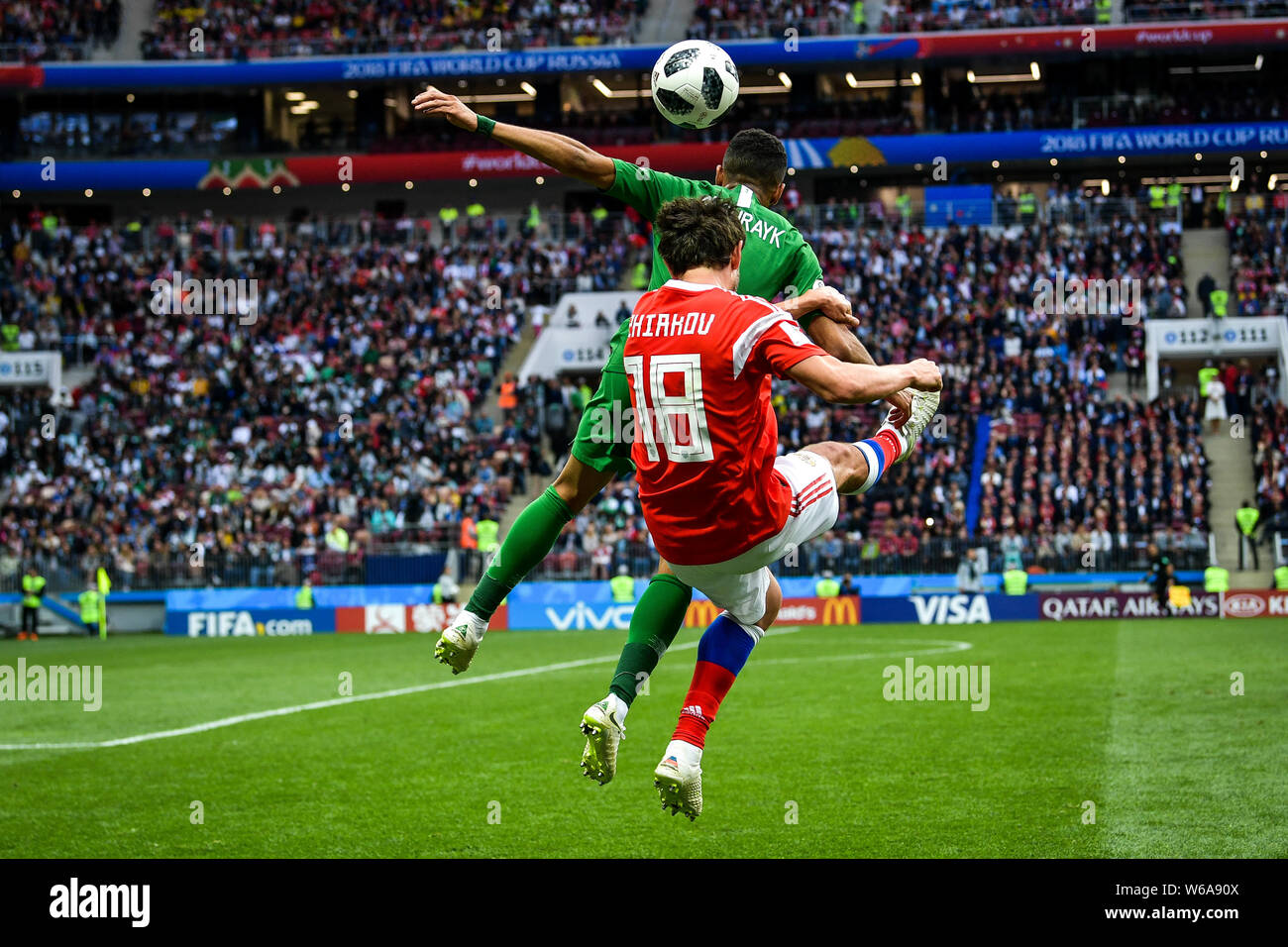 Yuri Zhirkov of Russia, front, heads the ball against a player of Saudi Arabia in their Group A match during the 2018 FIFA World Cup in Moscow, Russia Stock Photo