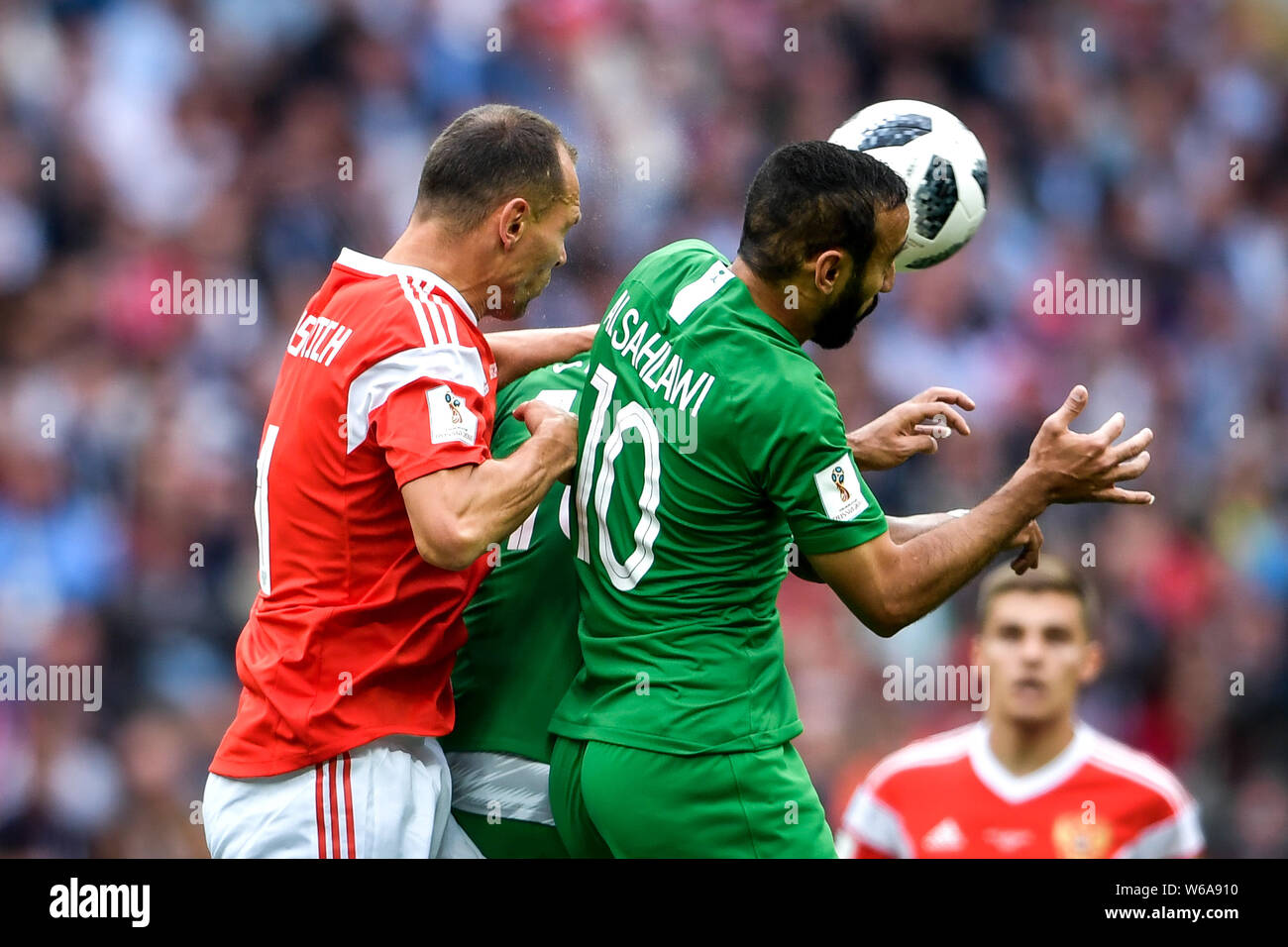 Sergei Ignashevich of Russia, left, challenges Mohammad Al-Sahlawi of Saudi Arabia in their Group A match during the 2018 FIFA World Cup in Moscow, Ru Stock Photo