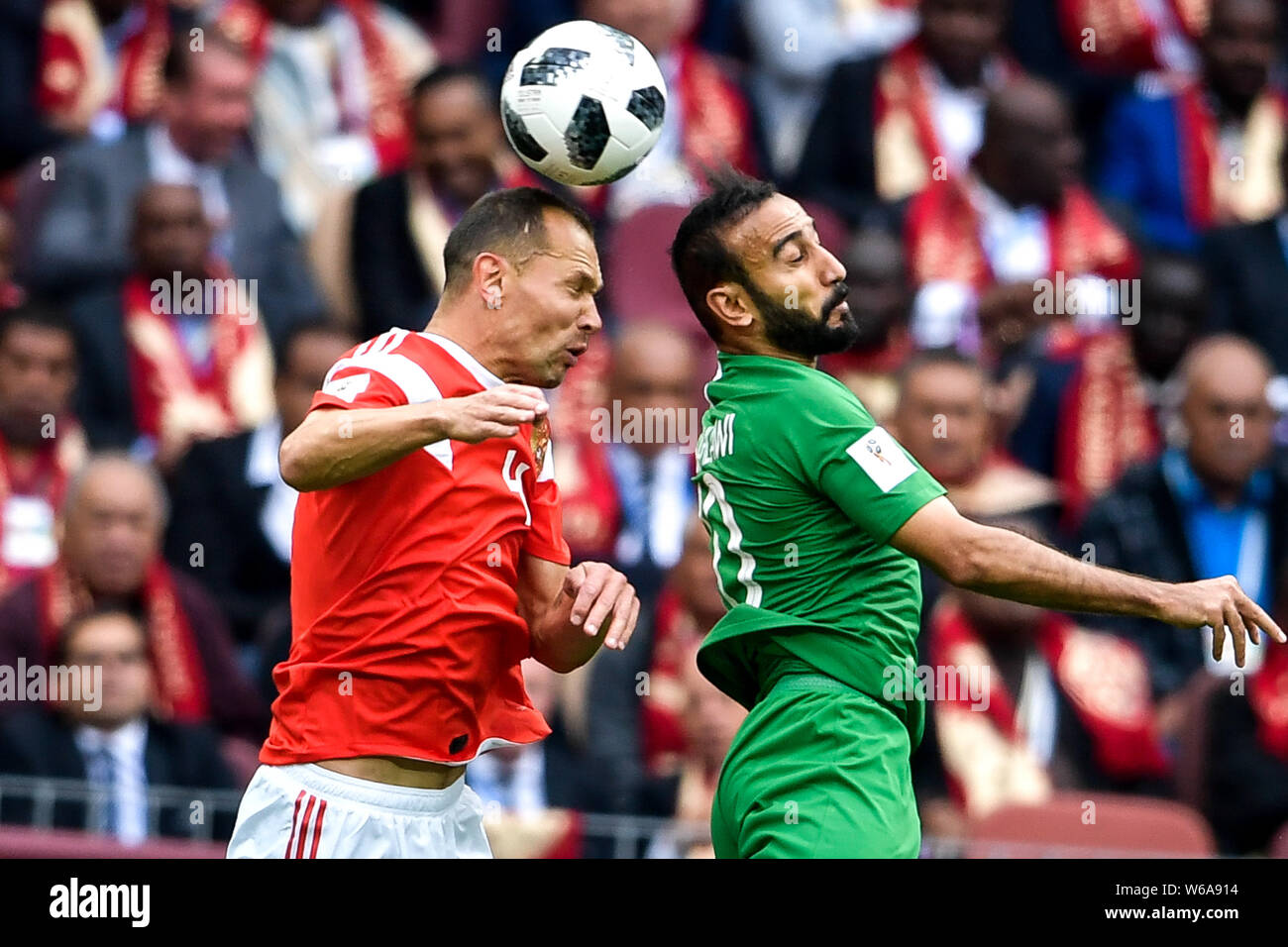 A player of Russia, left, heads the ball against Mohammad Al-Sahlawi of Saudi Arabia in their Group A match during the 2018 FIFA World Cup in Moscow, Stock Photo