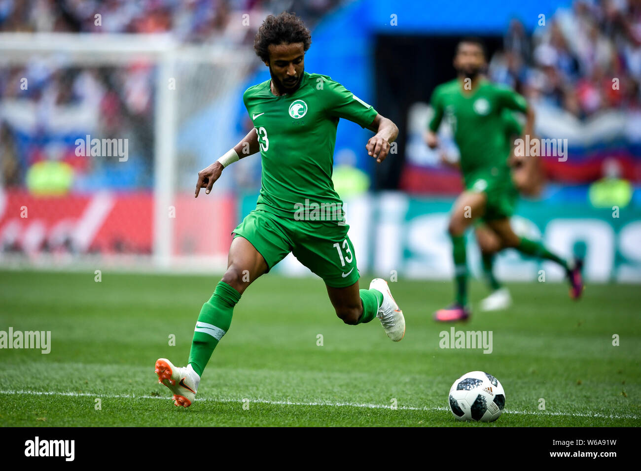 Yasser Al-Shahrani of Saudi Arabia dribbles against Russia in their Group A match during the 2018 FIFA World Cup in Moscow, Russia, 14 June 2018.   Ru Stock Photo