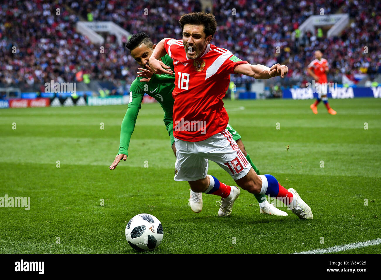 Yuri Zhirkov of Russia, right, challenges a player of Saudi Arabia in their Group A match during the 2018 FIFA World Cup in Moscow, Russia, 14 June 20 Stock Photo