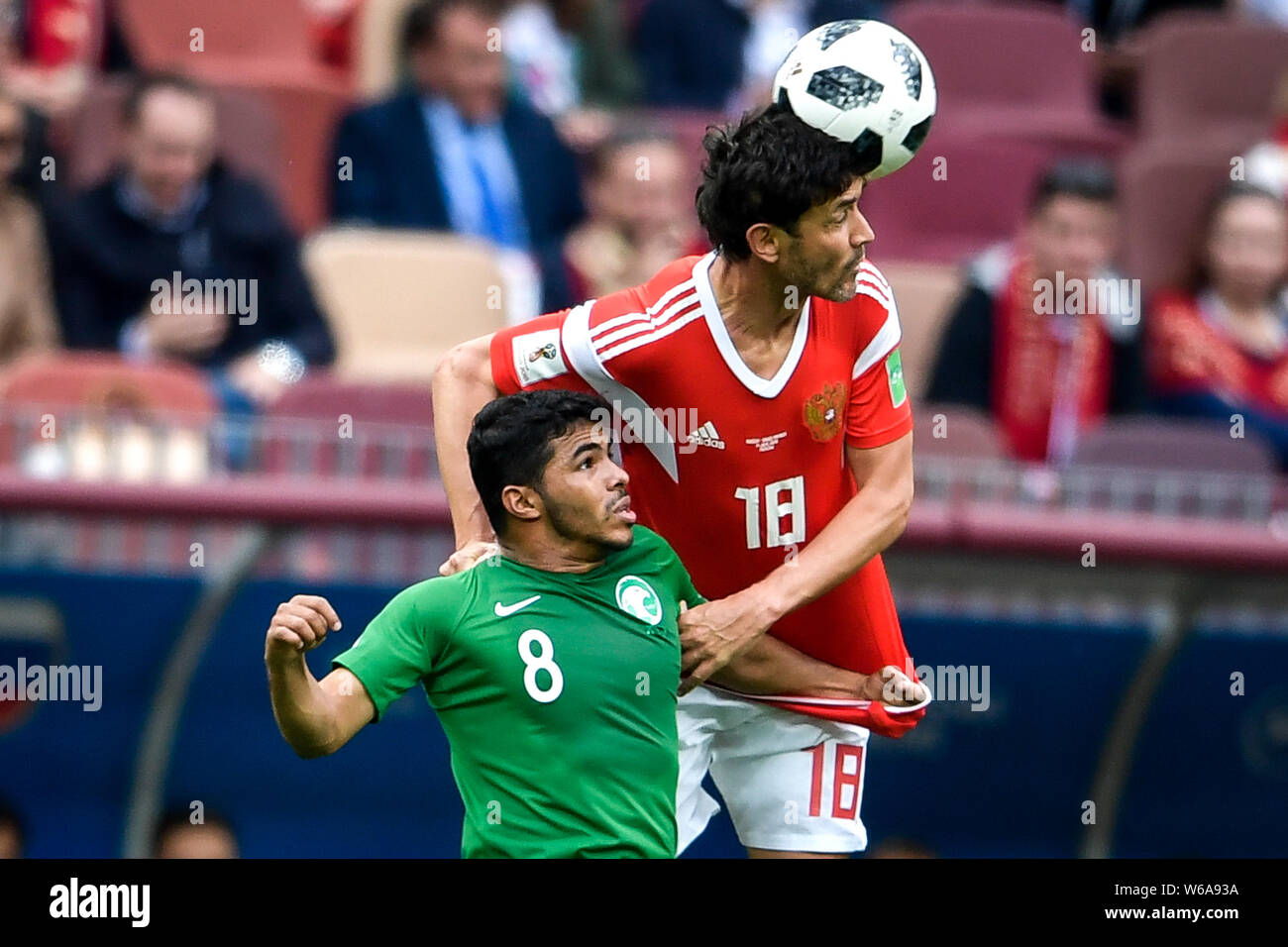 Yuri Zhirkov of Russia, right, heads the ball against Yury Gazinsky of Saudi Arabia in their Group A match during the 2018 FIFA World Cup in Moscow, R Stock Photo