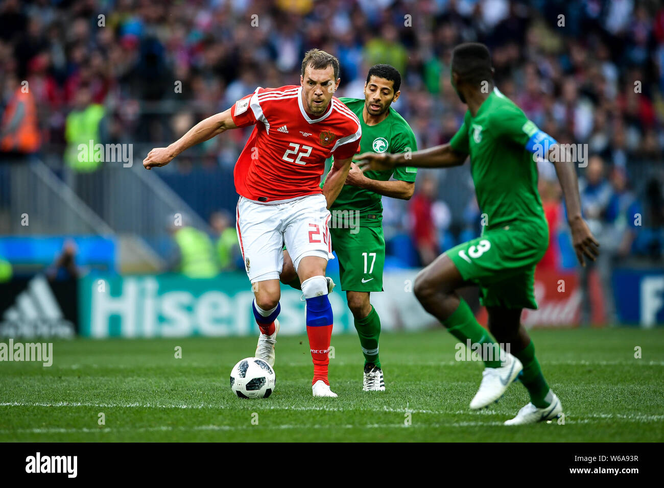 Daler Kuzyayev of Russia, left, challenges Taisir Al-Jassim of Saudi Arabia in their Group A match during the 2018 FIFA World Cup in Moscow, Russia, 1 Stock Photo