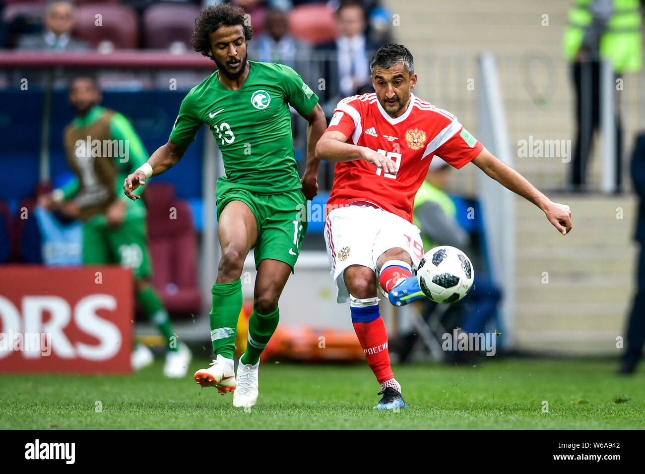 Aleksandr Samedov of Russia, right, challenges Yasser Al-Shahrani of Saudi Arabia in their Group A match during the 2018 FIFA World Cup in Moscow, Rus Stock Photo