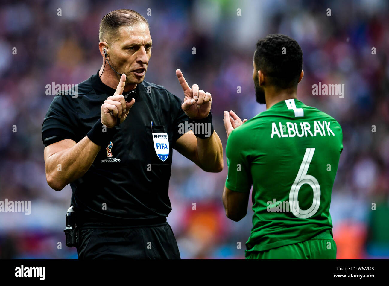 Referee Nestor Pitana talks with Mohammed Al-Breik of Saudi Arabia in their Group A match against Saudi Arabia during the 2018 FIFA World Cup in Mosco Stock Photo
