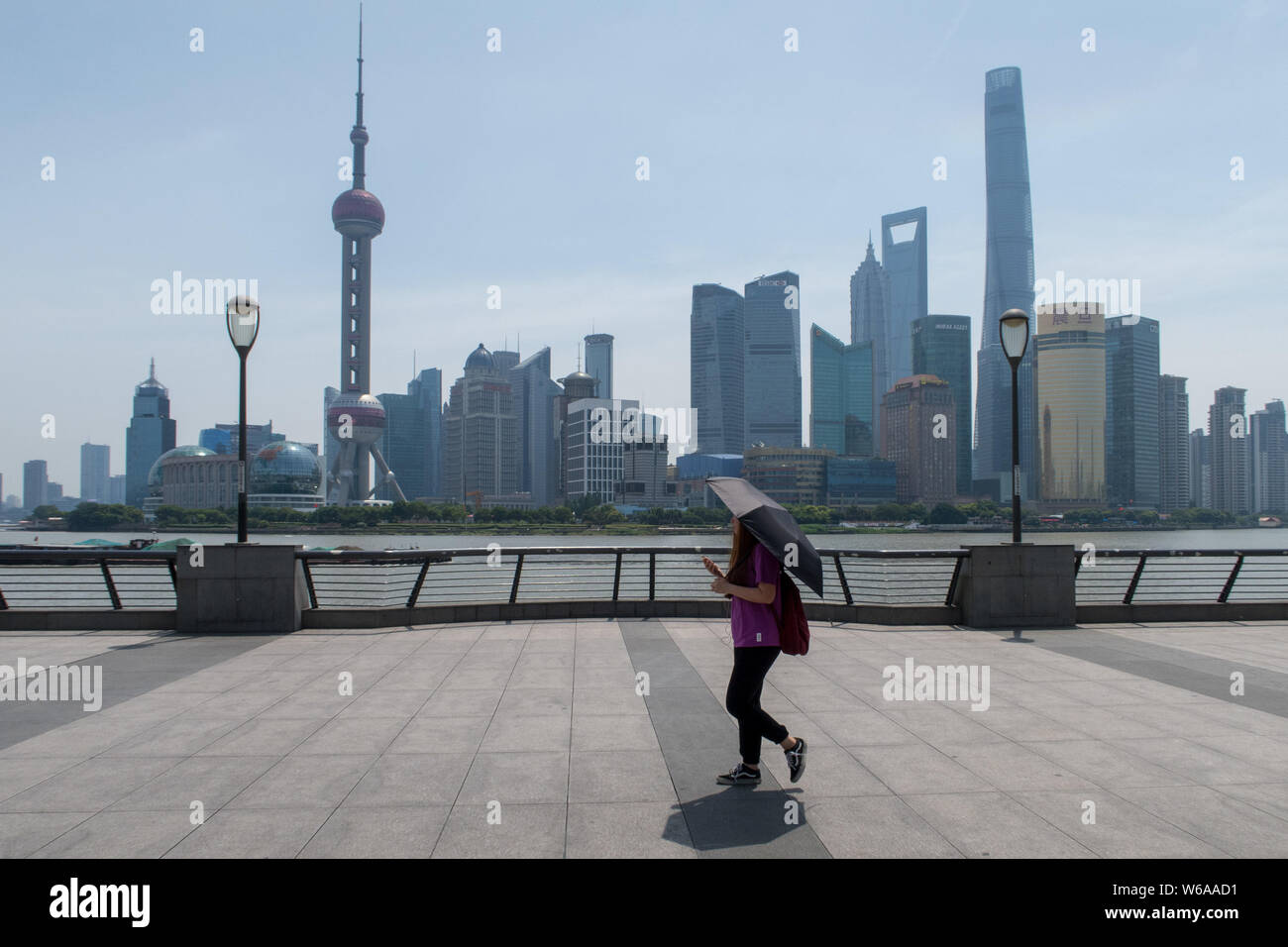 A Tourist Shields Herself With An Umbrella From The Scorching Sun As She Visits The Bund In Shanghai China 26 June 18 Shanghai Weather Bureau I Stock Photo Alamy