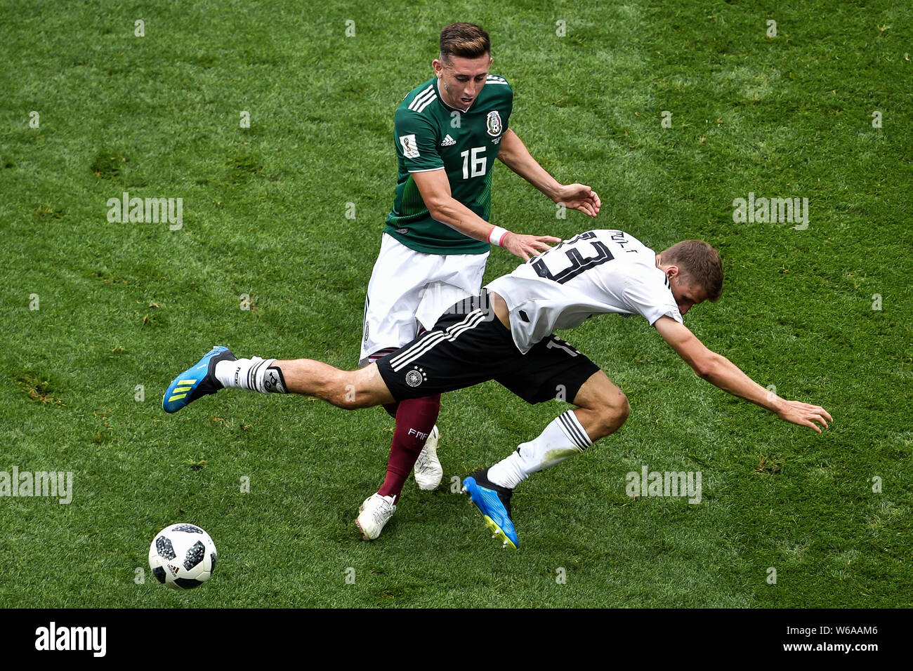 Hector Herrera of Mexico, back, challenges Thomas Mueller (Muller) of Germany in their Group F match during the FIFA World Cup 2018 in Moscow, Russia, Stock Photo