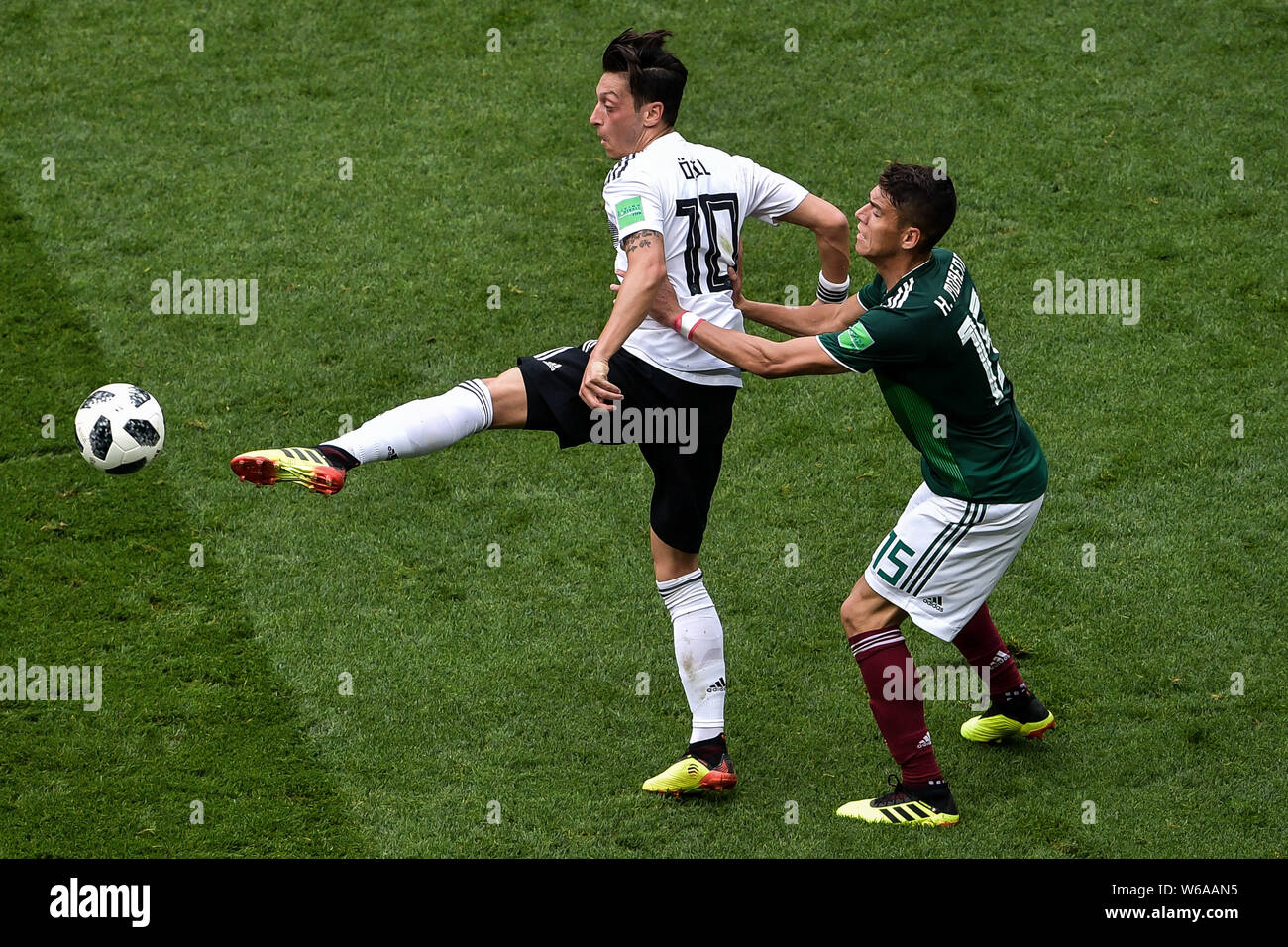 Mesut Oezil (Ozil) of Germany, left, challenges Hector Moreno of Mexico in their Group F match during the FIFA World Cup 2018 in Moscow, Russia, 17 Ju Stock Photo